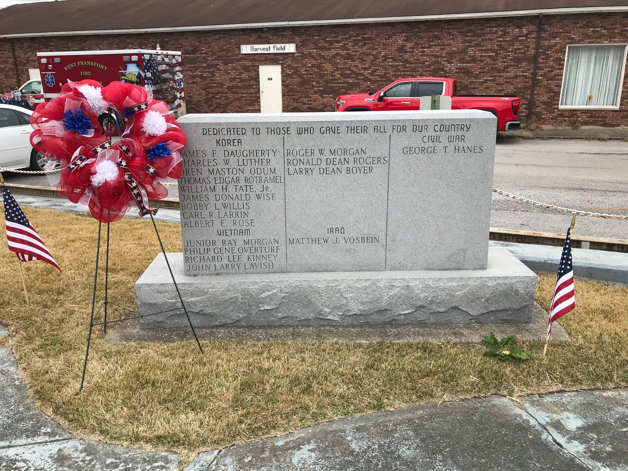 Veterans memorial stone honoring local heroes with a patriotic wreath