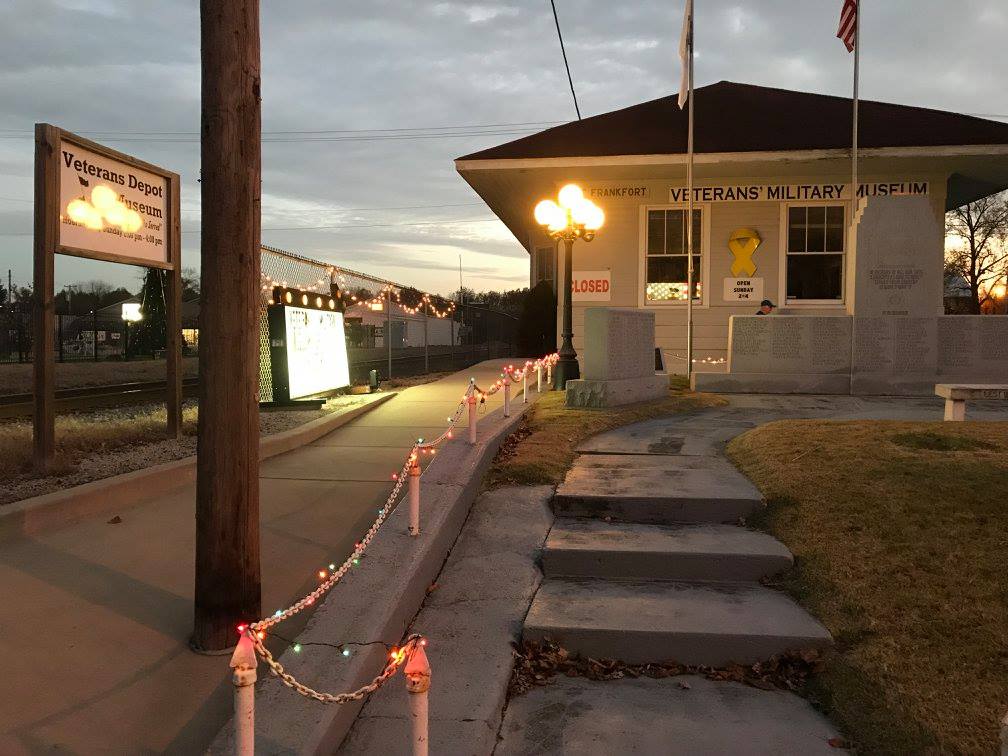 Evening view of the museum exterior lit with string lights