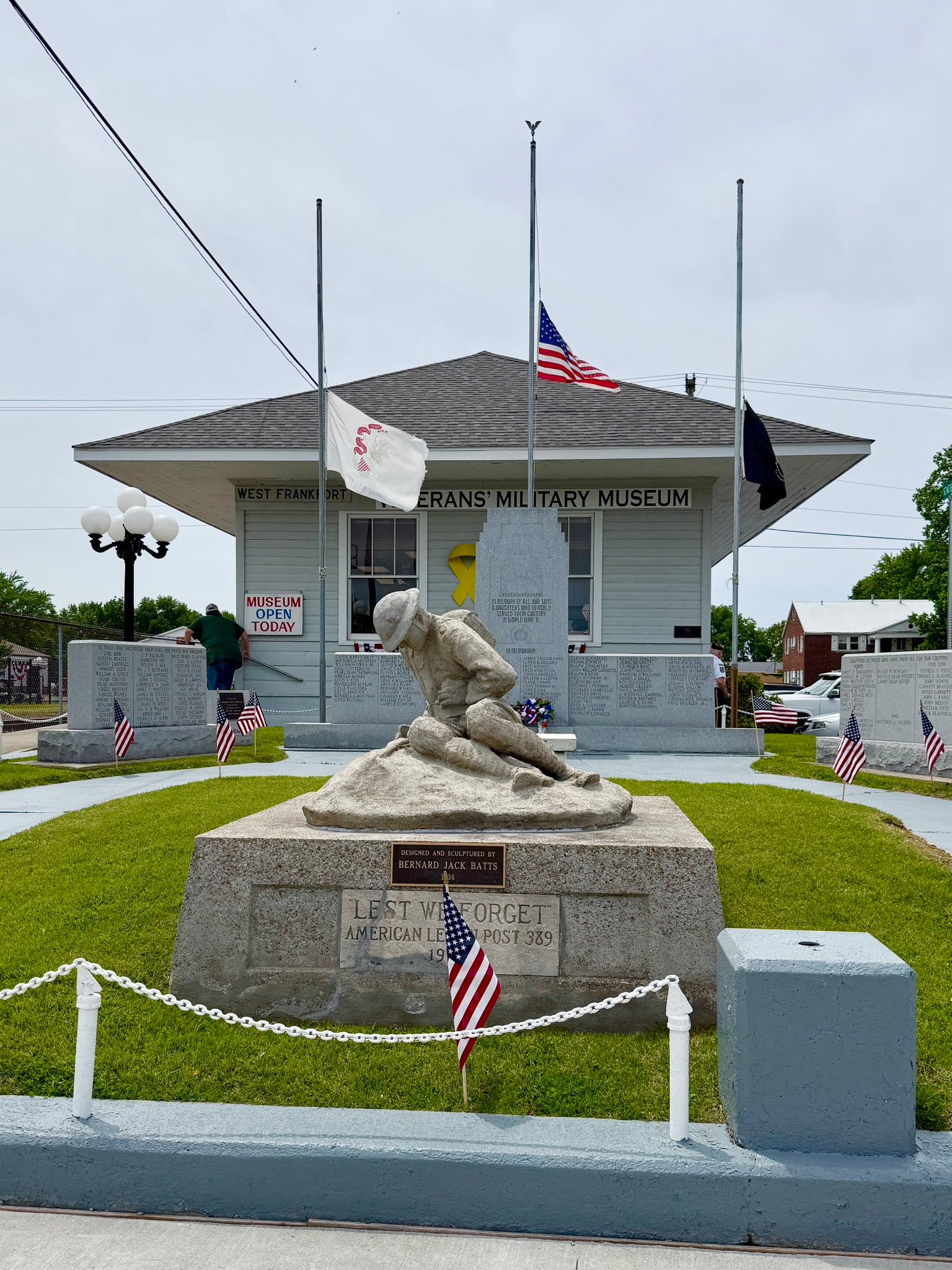 Veterans Military Museum exterior with kneeling soldier statue and flags